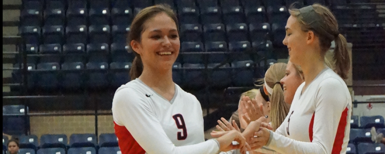 Sophomore Mandy Ramirez gives high fives as her name is called on the loud speaker on Sep. 4.