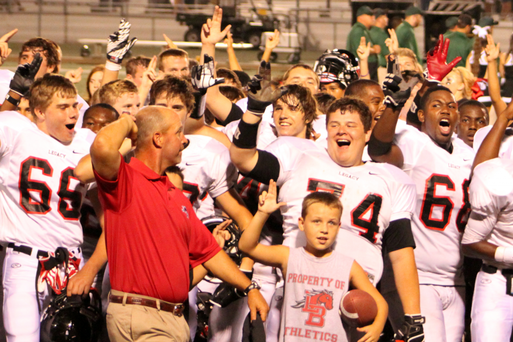 Head+Coach+Chris+Melson+celebrates+the+first+win+of+the+season+with+the+team+on+Sep.+7+against+Kennedale.