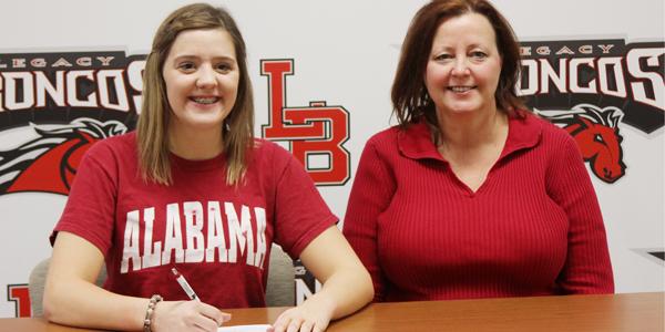 Senior Sarah Musselman sits next to her mother while signing with the University of Alabama.