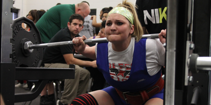 Senior Leanne Flores squats during the first meet of the Powerlifting season.