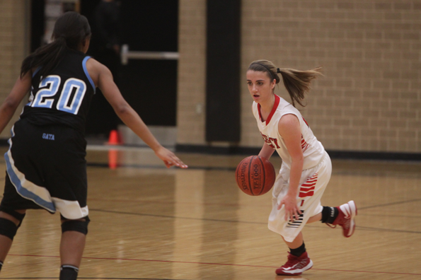 Sophomore Channa Parvin dribbles across the gym.