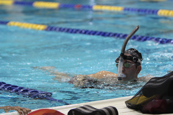 Felina Moniz, 12, uses a snorkel to work on breath control drills during swim practice.