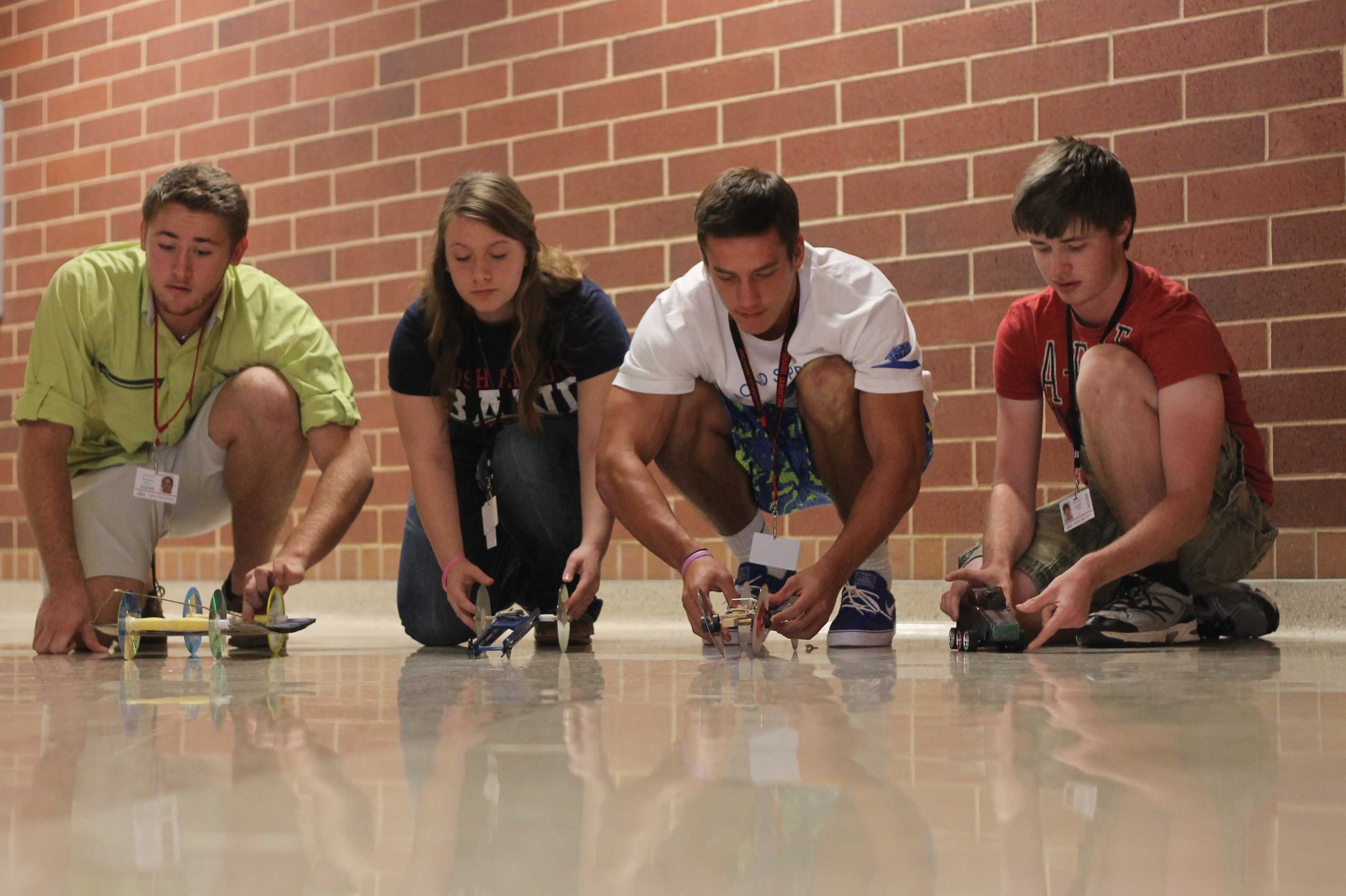 Students prepare to race their cars in physics class