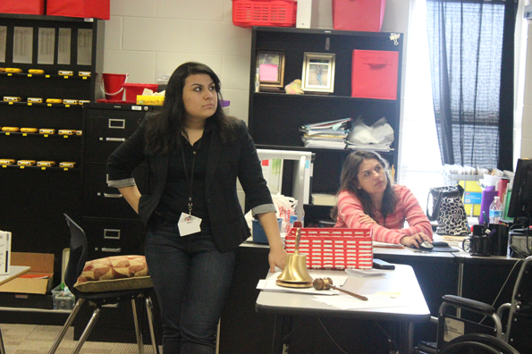 Briana Mendoza, 12, discusses her power point presentation to the members of Key Club. 