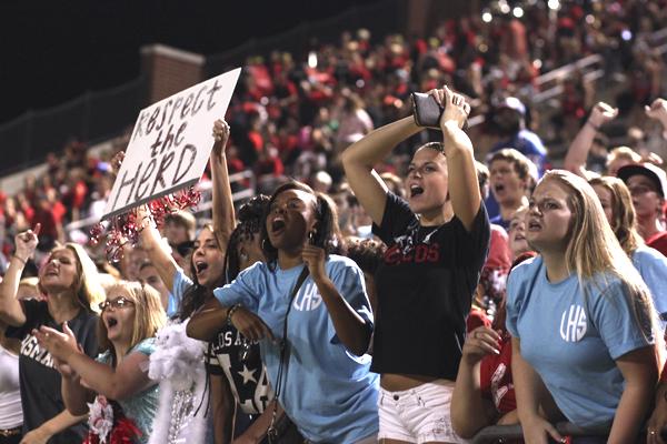 Seniors Hailey Mitchell, Rhyan Smith and junior Zariah Medlock yell during a home football game.