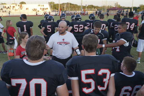 Coach Keel gives a motivational speech to players during the JV game.