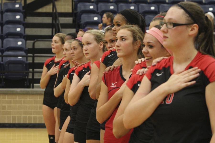 Payton+Burney%2C+Lexi+Contos%2C+Madison+Potter+and+other+volleyball+players+stand+during+the+National+Anthem.+
