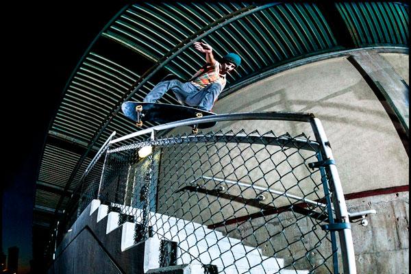 Marshall Stinson skates down a stairwell on his skateboard.