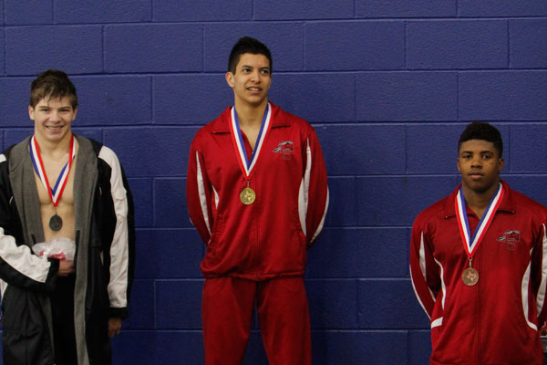Senior Brandon Bernall poses for his picture after placing first in his event at the district meet.
