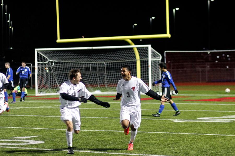 Roberto Espinoza, 11, celebrates scoring a goal against Midlothian High School with Alex Duppstapt, 12, who provided the assist.