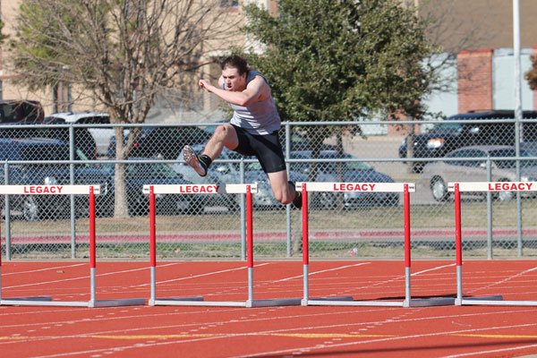 Garrett Moore, 12, competes in the hurdles event during a track meet. 