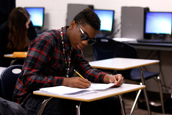 Eric Womack, 10, works on classwork during Mr. Ritz debate class.