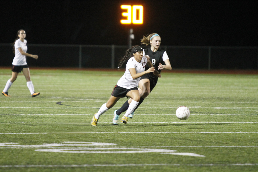 Dezirae Rodriguez, 9, battles with an opponent for the ball during a crucial district game against Mansfield Timberview.