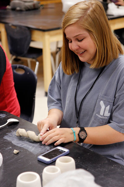 In Mr. Skinners Art II Ceramics class, Lauren Wilke, 12, smooths out a sculpted spoon handle for her project. (Maddy Brown photo)
