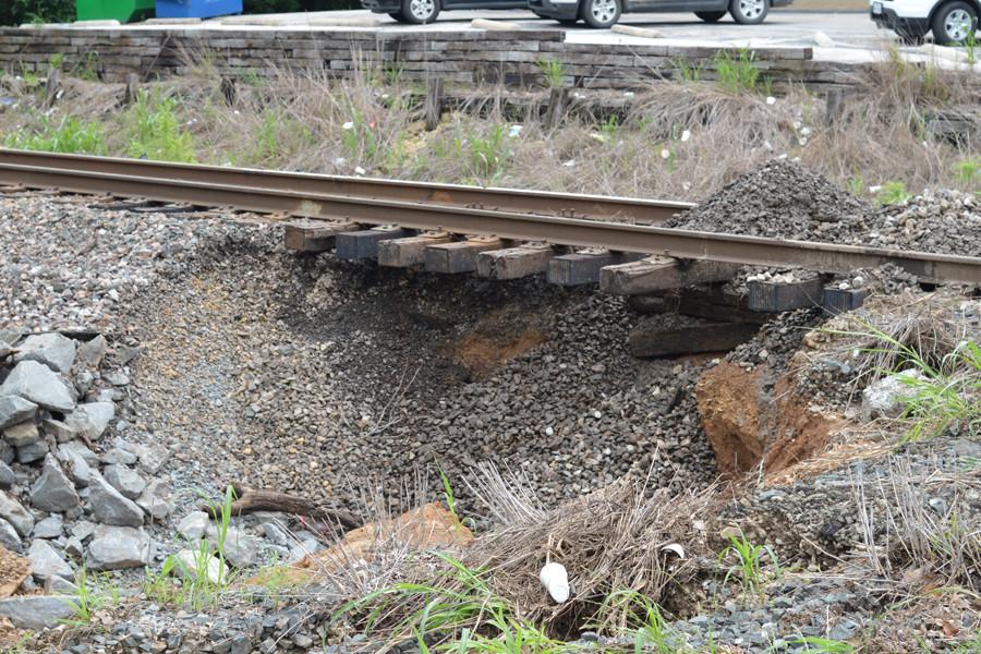 Part of the rail line lays without a foundation after rain swept it away.