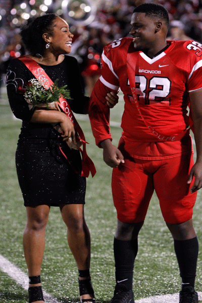All smiles from Craig Nealy and Talyn Moody, 12, as they are announced the 2015 Homecoming King and Queen at the Legacy vs. Fort Worth South West game on Sept. 11. (Maddy Brown photo)