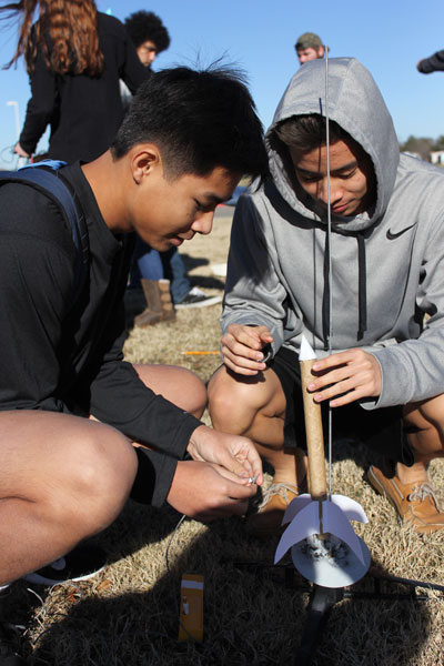 Brian Pham, 11, and Sam Sok, 11, make last minute adjustments to their rocket before they set it off in Mr. Davis AP Physics class on Jan 15.  (Megan Bell photo)