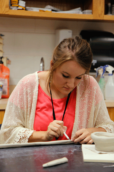 In Mr. Skinners Art II Ceramics class, Rylee Loveland, 12, cuts hand made coils for her wheel thrown pot. (Maddy Brown Photo) 