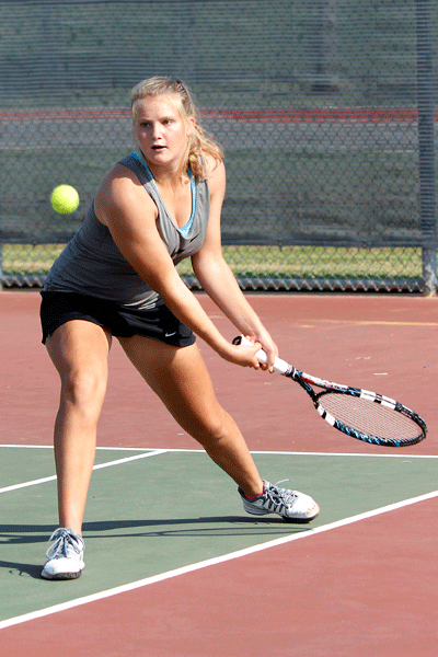 Varsity player Kaitlyn Roberts, 11, returns a serve to her opponent at the Legacy vs Segiun tennis match on Sept 29.  (Maddy Brown photo)