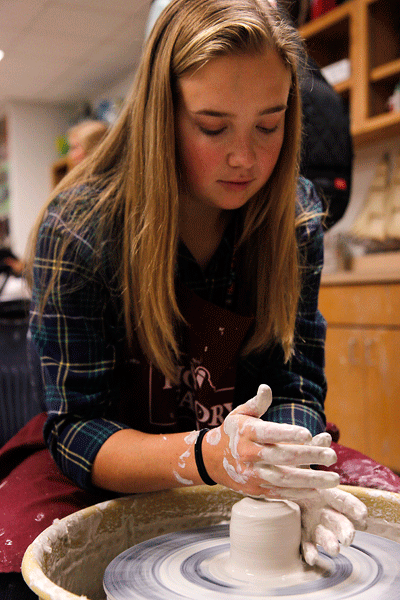 In Mr. Skinners Art 2 Ceramics class, Lisa Hart, 12, learns how to throw a wheel piece. (Maddy Brown photo)
