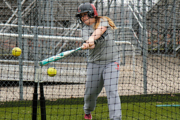 Brianna Thompson, 10, practices hitting of a tee on Feb. 1 at softball practice. (Tori Greene photo)