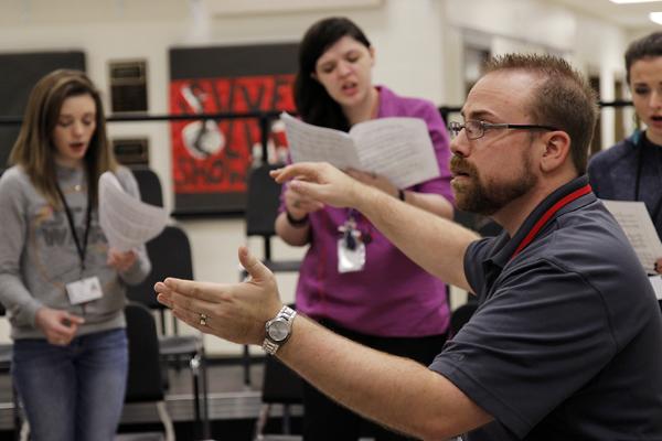 Mr. Josh Powell conducts the womens section of chamber choir on Feb. 29 in the choir room. (Maddy Brown photo)