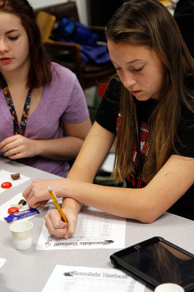 In Mrs. Esailis AP Human Geography class, Kamryn Blevins, 9, analyzes the color, texture and taste if different types of chocolate while learning about the chocolate trade and child slavery. (Maddy Brown photo)