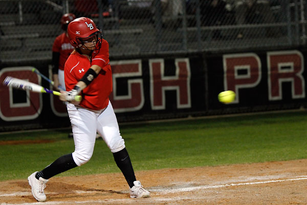 Megan Dake, 11, swings at the ball at the varsity girls softball game versus Red Oak. (Maddy Brown photo)