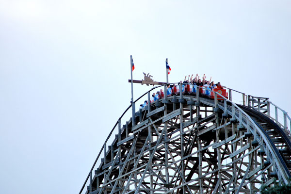 People ride The Texas Giant - the tallest hybrid roller coaster in the world.