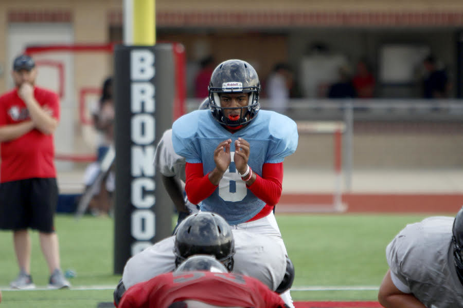 Quarterback Kendall Catalon, 11, prepares to receive the ball and start a play during preseason practices.