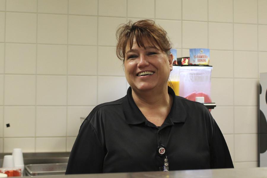 Lunch worker Janet Luttrel serves food to students