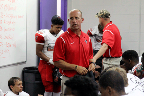 Head varsity football coach, Chris Melson, talks with the varsity team before a game. He won the class 3A Oklahoma high school state football game in 1986. 