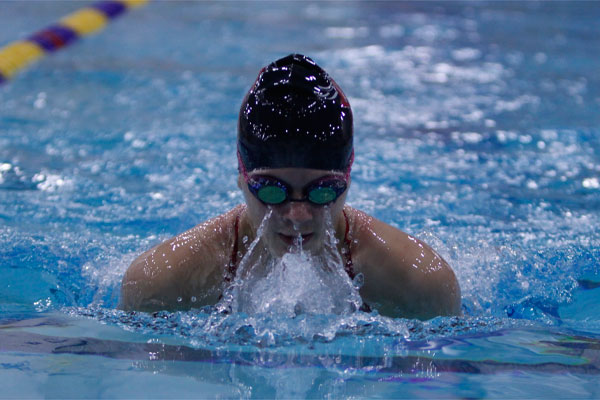 Junior Madison Koceich swims breaststroke against Keller at the first meet of the year.