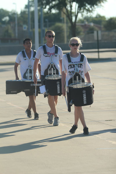 Drumline practices after school in the parking lot. 