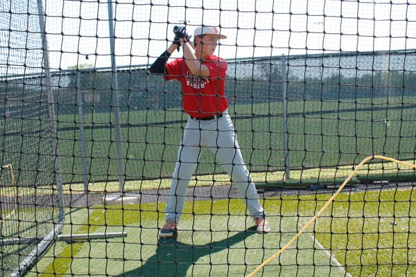 Baseball player Ryan Hill practices after school. 