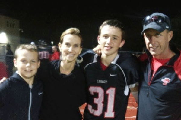 Jorden Melson (#31) poses with his younger brother Major, his mother and father, Coach Melson after the last game of the Freshman A Football season. [photo from Facebook]