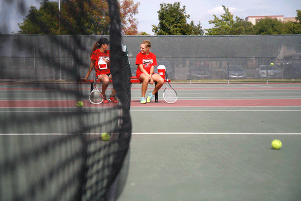 Tennis players practice after school. 