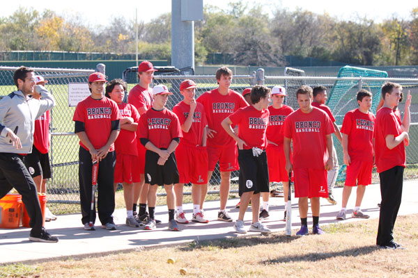 The baseball team gathers with new head coach, Chris McMullen, for a hitting drill. 