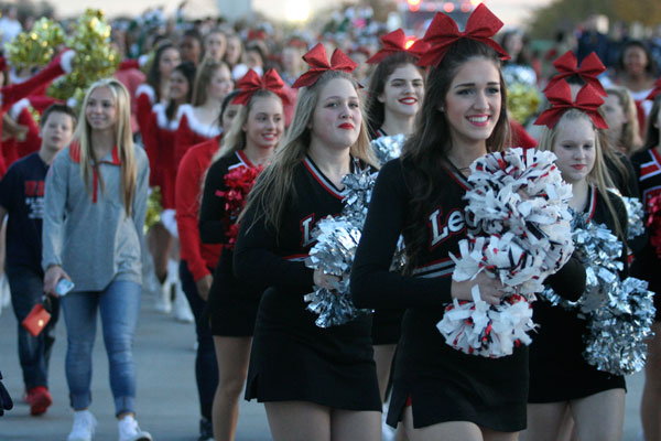 Rylee Cortines, 11, and fellow Legacy High School cheerleaders walk in the Toys for Tots parade.(Dalton Mix photo)