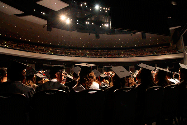 Class of 2015 graduates wait on stage before walking the stage at the Mansfield ISD Center of Performing Arts.