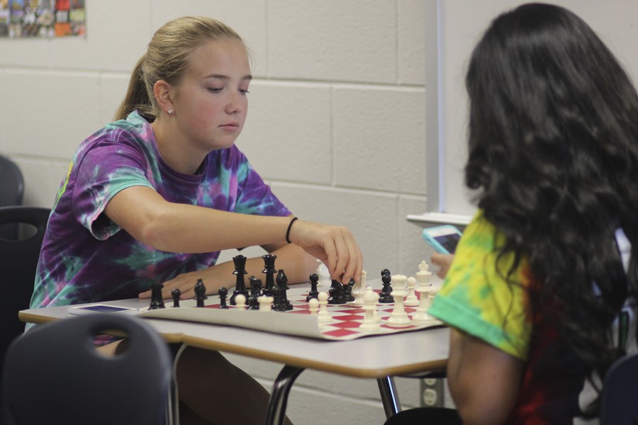 Lisa Hart, 12, advances one of her pawns while playing chess at Chess Club.
