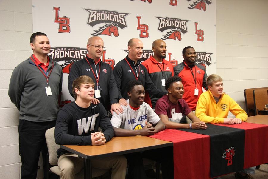 Football+seniors+Brett+Bloodworth%2C+Darryl+Thomas%2C+Jermaine+Brealy+and+Austin+Franks+sign+to+their+select+colleges+on+National+Signing+Day.+