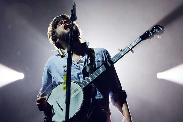 One of Mumford and Sons members, Winston Marshall, plays the banjo at a show.