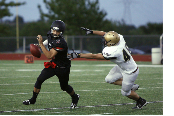 Cameron Clark, 10, runs to avoid a tackle from a Wichita Falls player during a JV football game. 