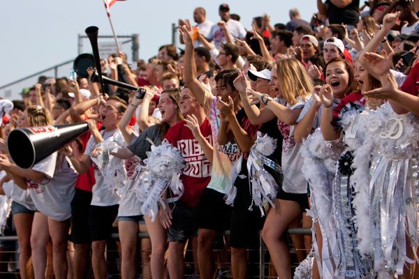 [File Photo] Students cheer on the football team at homecoming.