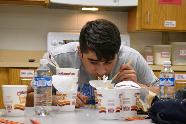 Ryan Neira, 12, eats ramen noodles during the Anime Club ramen noodle eating contest. Neira won by eating a total of four cups of ramen. 