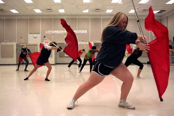 Rebecca Roberts, 11, and the other winter guard members practice techniques for upcoming competitions. 