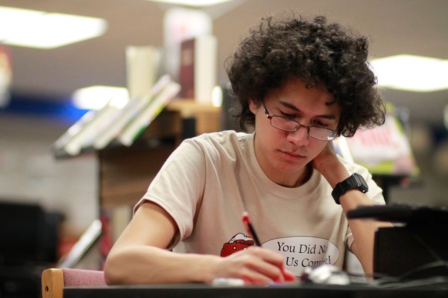 Senior Ethan Wikoff takes one of his ten tests during the Summit High School District Invitational on Dec. 2. The AcaDec team will advance to the state tournament in El Paso, Texas on Feb. 23-26. 