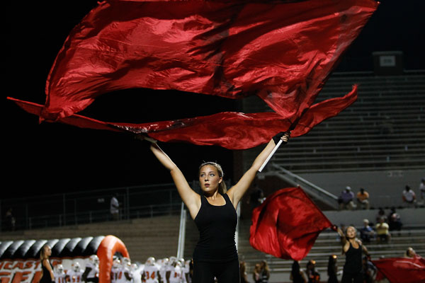Katelin Criswell, 12, performs with the color guard during a Friday night football game.