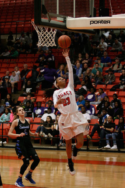 Harmoni Turner, 9, completes a lay-up during the round three playoff game against Burleson Centennial. 